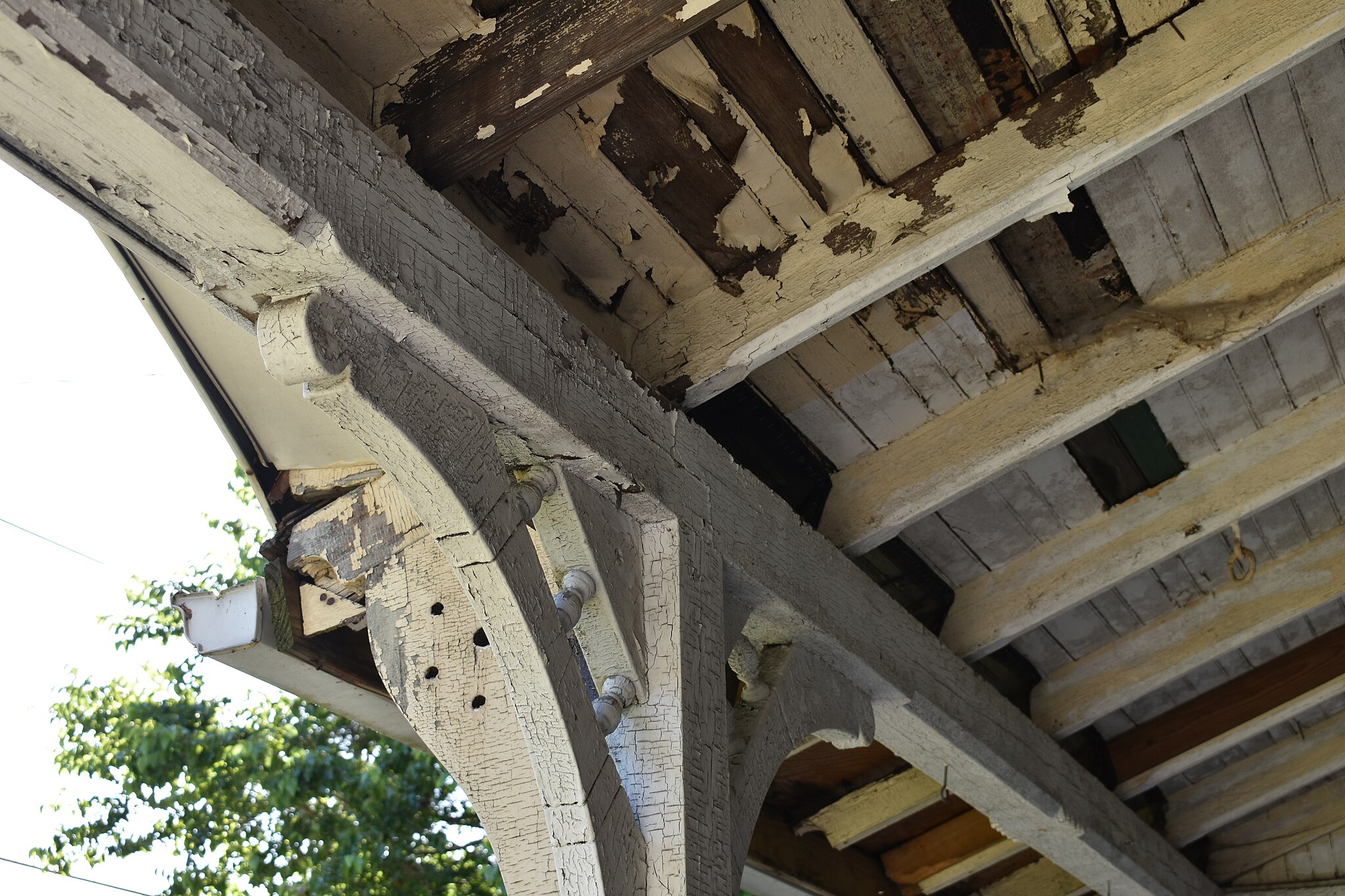 Chipping lead-based paint on residential porch posing potential health hazard